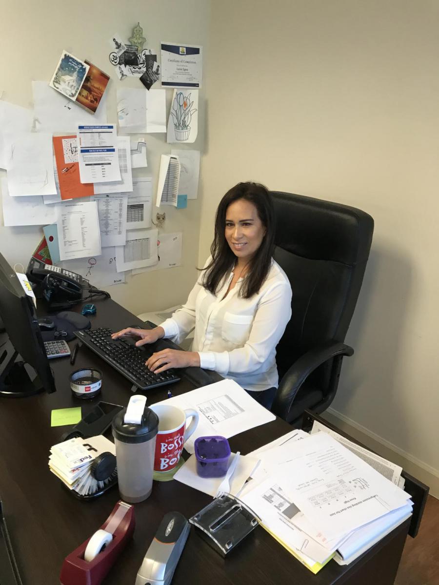 Image of Luisa Egea sitting at desk in office.