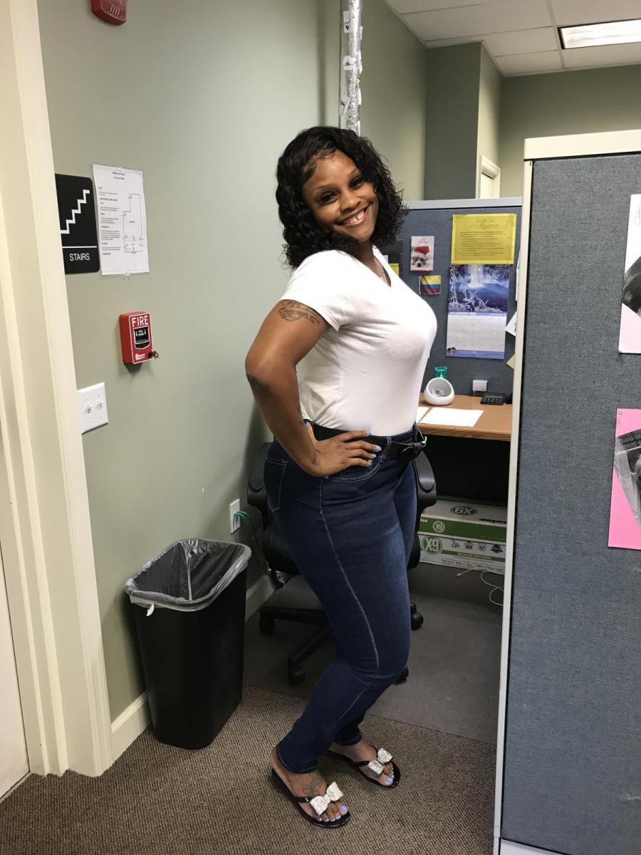 Image of Nicole Greene standing by her desk.